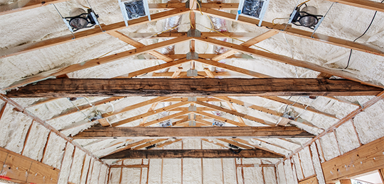 Commercial insulation installed in a warehouse ceiling.